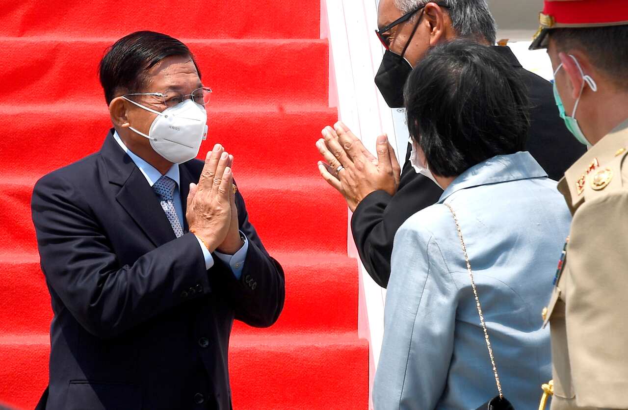 Myanmar's Senior General Min Aung Hlaing, left, is greeted by Indonesian officials at Soekarno-Hatta International Airport in Tangerang on Saturday, 24 April.
