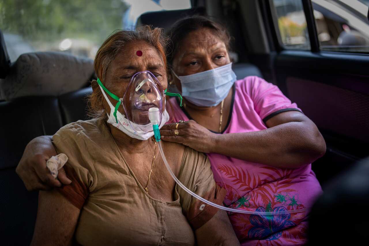 A COVID-19 patient receives oxygen inside a car provided by a Gurdwara, a Sikh house of worship, in New Delhi, India, Saturday, 24 April, 2021. 