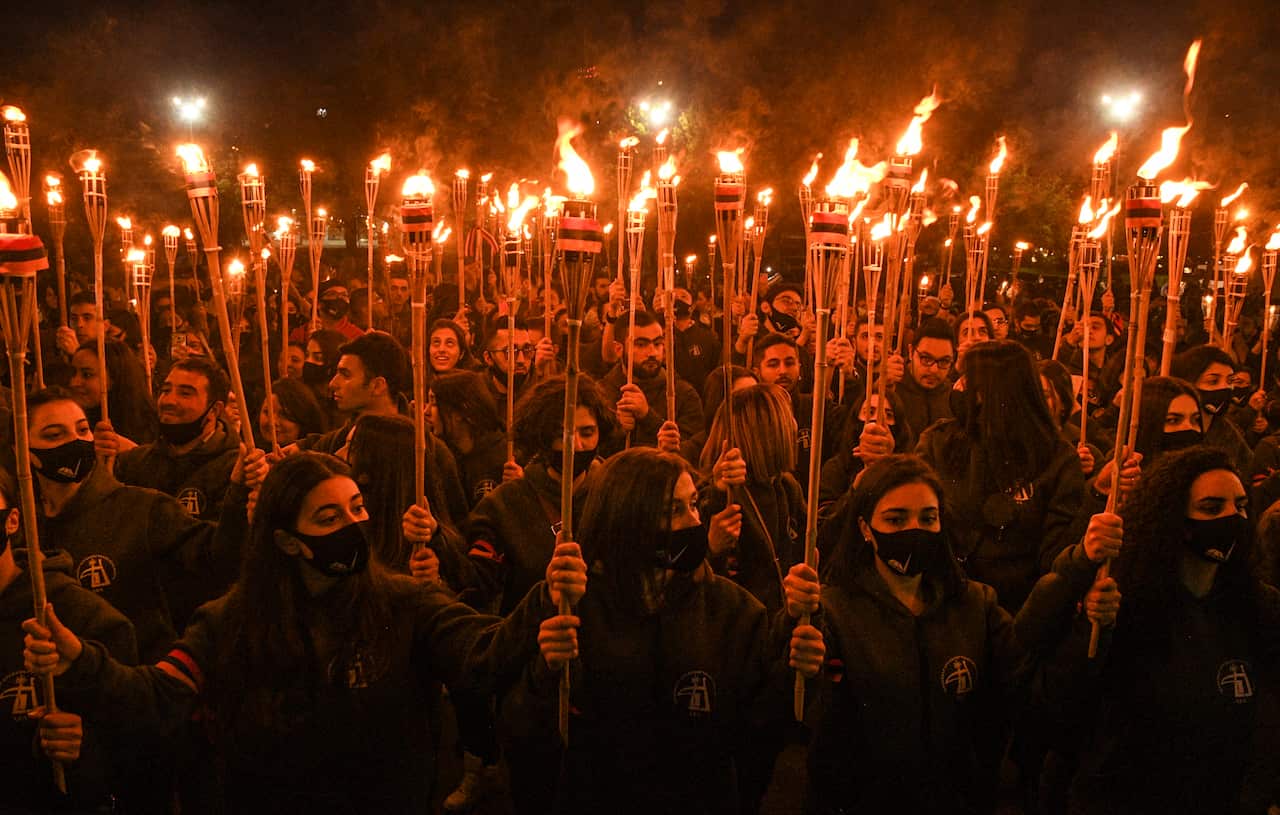 People take part in a traditional torchlight procession to mark the 106th anniversary of the mass killings of Armenians in the Ottoman Empire, in Yerevan