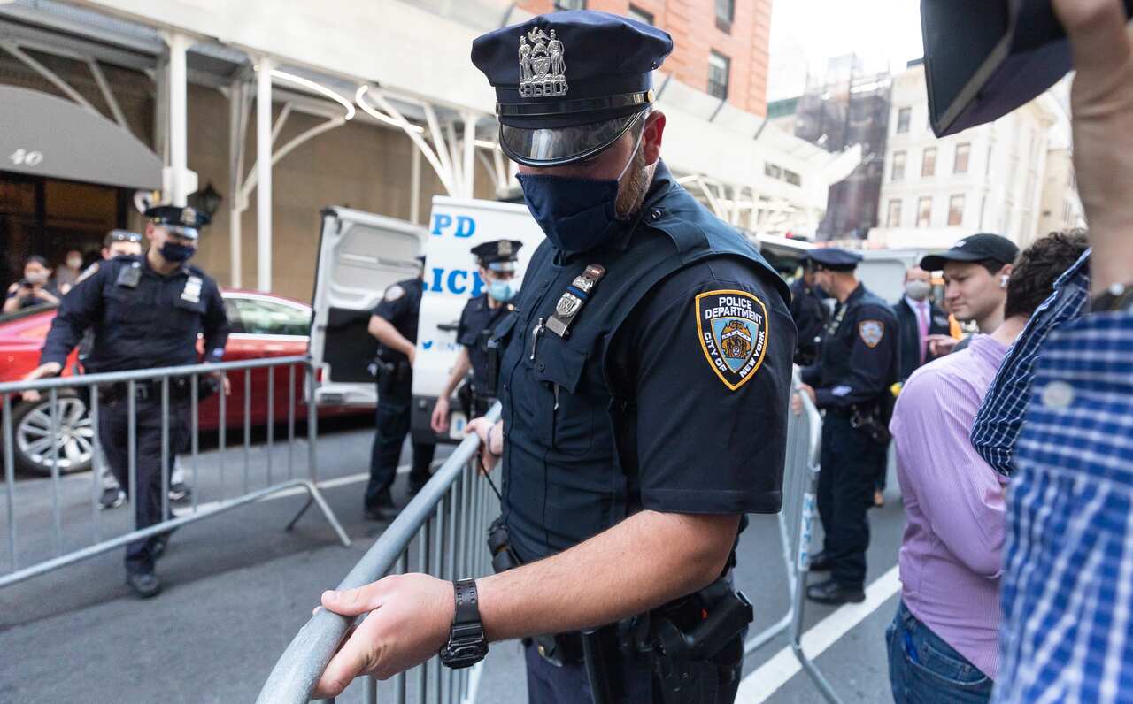 New York City police officers put barricades in the street outside of the building where Rudy Giuliani has an apartment