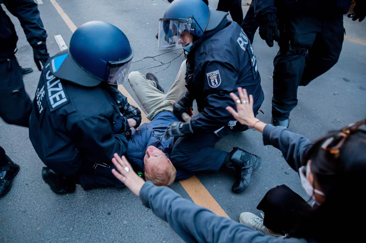 Berlin police officers hold a man on the ground during a May Day demonstration.