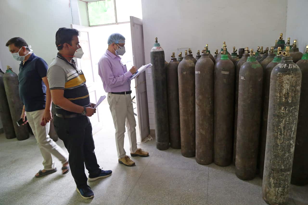 Health officers counts empty oxygen cylinders for refilling at an oxygen plant in Government Amrit Kaur Hospital in Beawar.