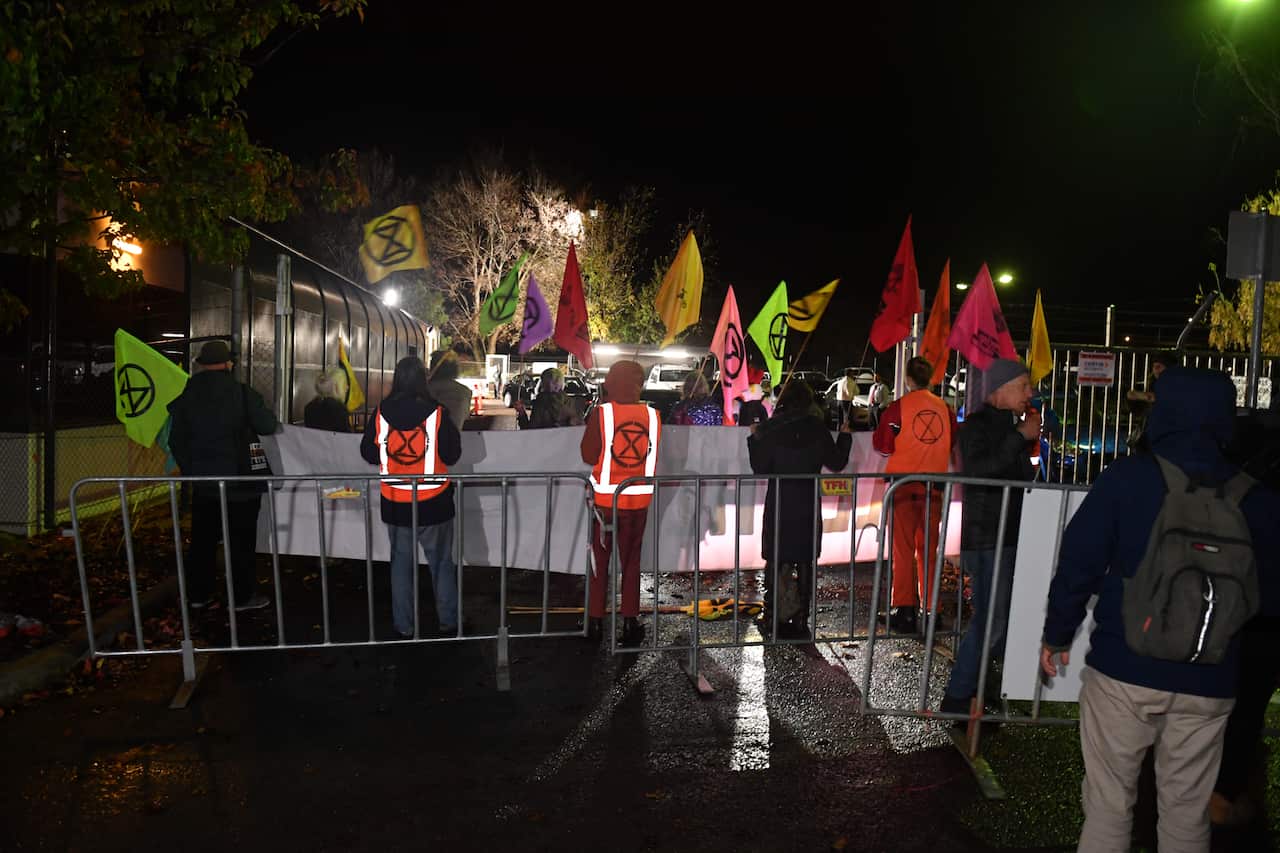 Extinction Rebellion blockade the entrances to the Comcar depot in Fyshwick, preventing the cars from taking politicians into Parliament House on Budget day.