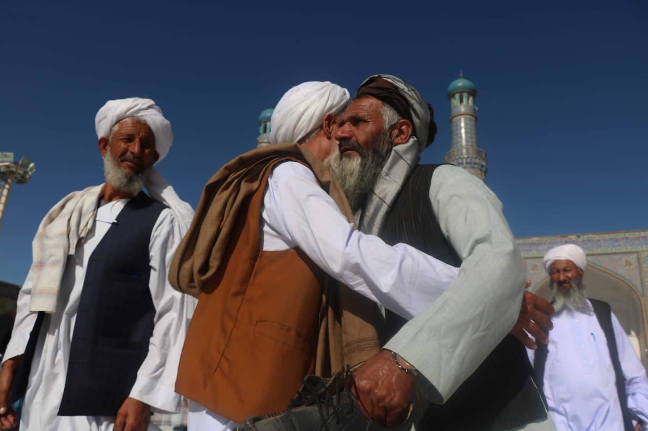 People greet each other after Eidl al-Fitr prayers in Herat, Afghanistan, on 13 May, 2021. 