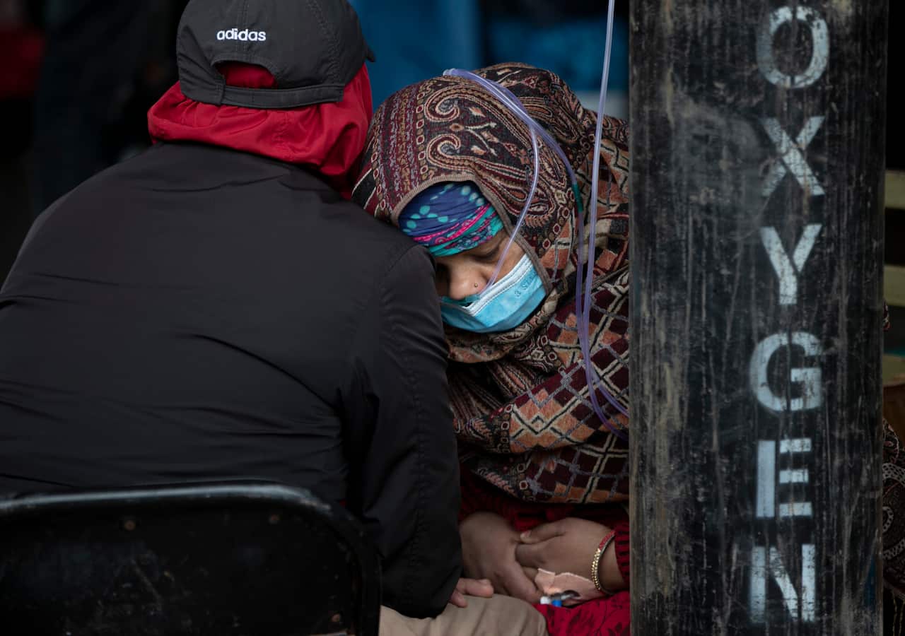 A COVID-19 patient receives oxygen outside an emergency ward at a government-run hospital in Kathmandu, Nepal on Thursday, 13May, 2021.
