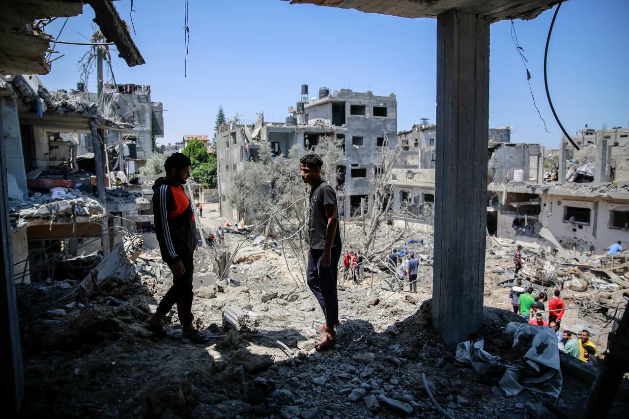 Palestinians gather at destroyed houses as cross-border violence between the Israeli military and Palestinian militants continues, in the northern Gaza Strip.