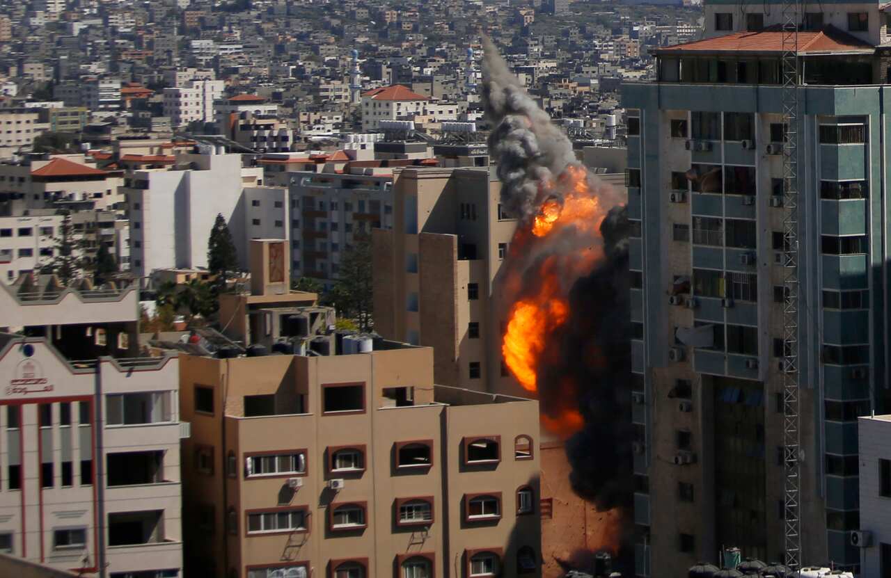 An Israeli airstrike hits the high-rise building housing media offices in Gaza City, Saturday, May 15, 2021