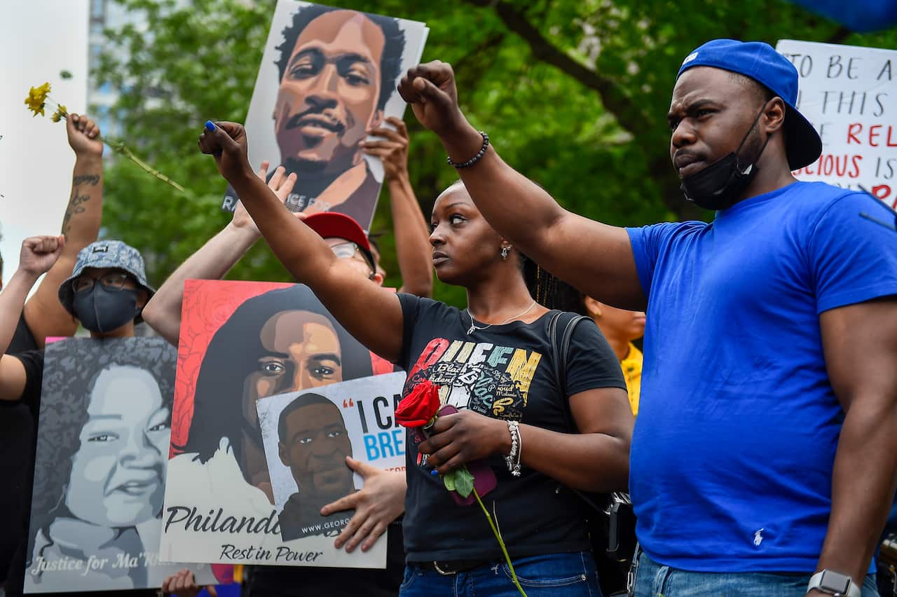 Protesters march through the streets in Minneapolis to commemorate the anniversary of George Floyd's death, 23 May 2021. 