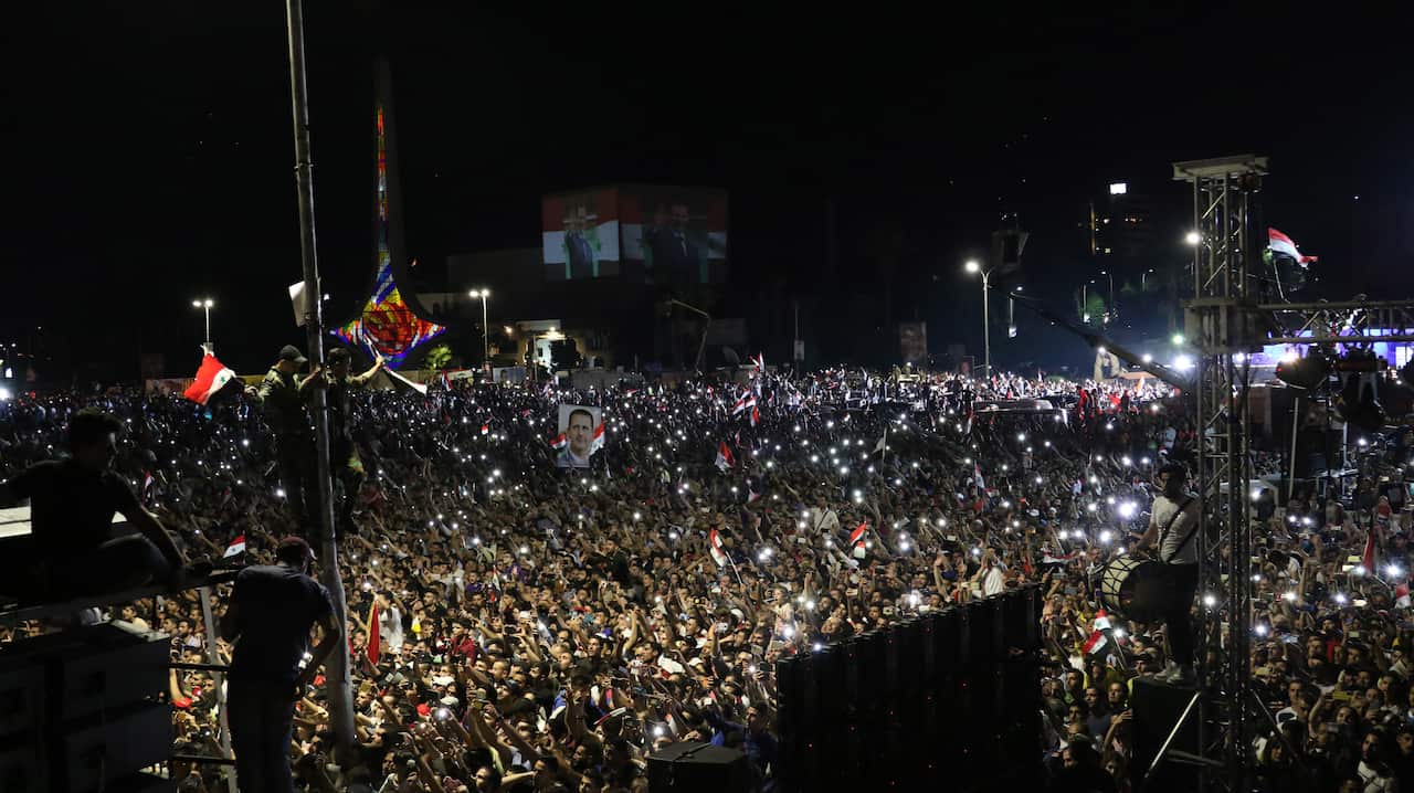 Supporters of Mr al-Assad celebrate his election win at the main Umayyad square in Damascus, Syria, on 27 May 2021.
