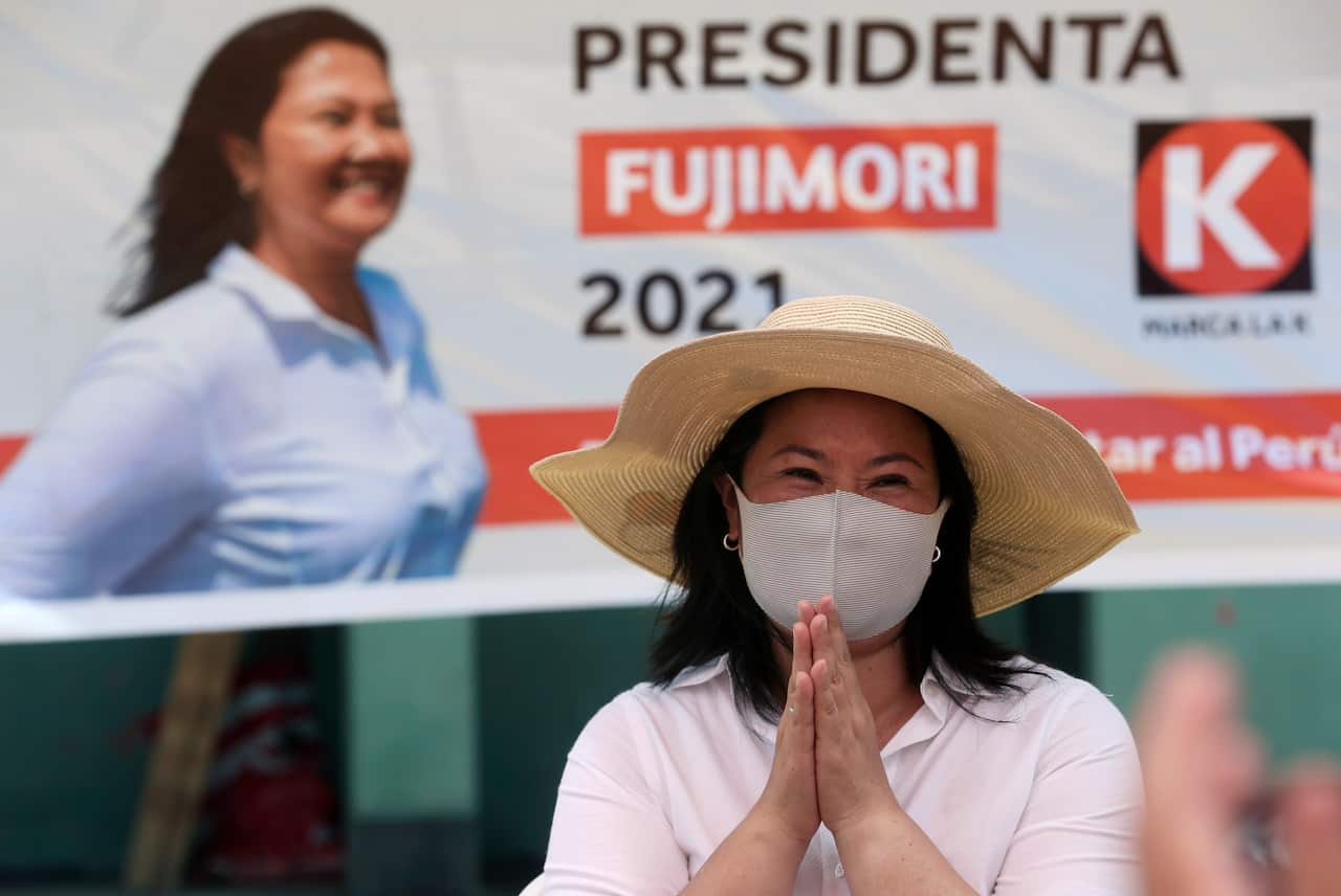 In this 24 March, 2021 file photo, presidential candidate Keiko Fujimori waves to supporters as she campaigns on the outskirts of Lima, Peru.