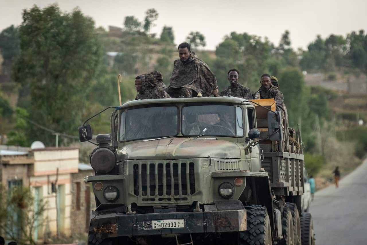 Ethiopian government soldiers ride in the back of a truck on a road leading to Abi Adi, in the Tigray region of northern Ethiopia.