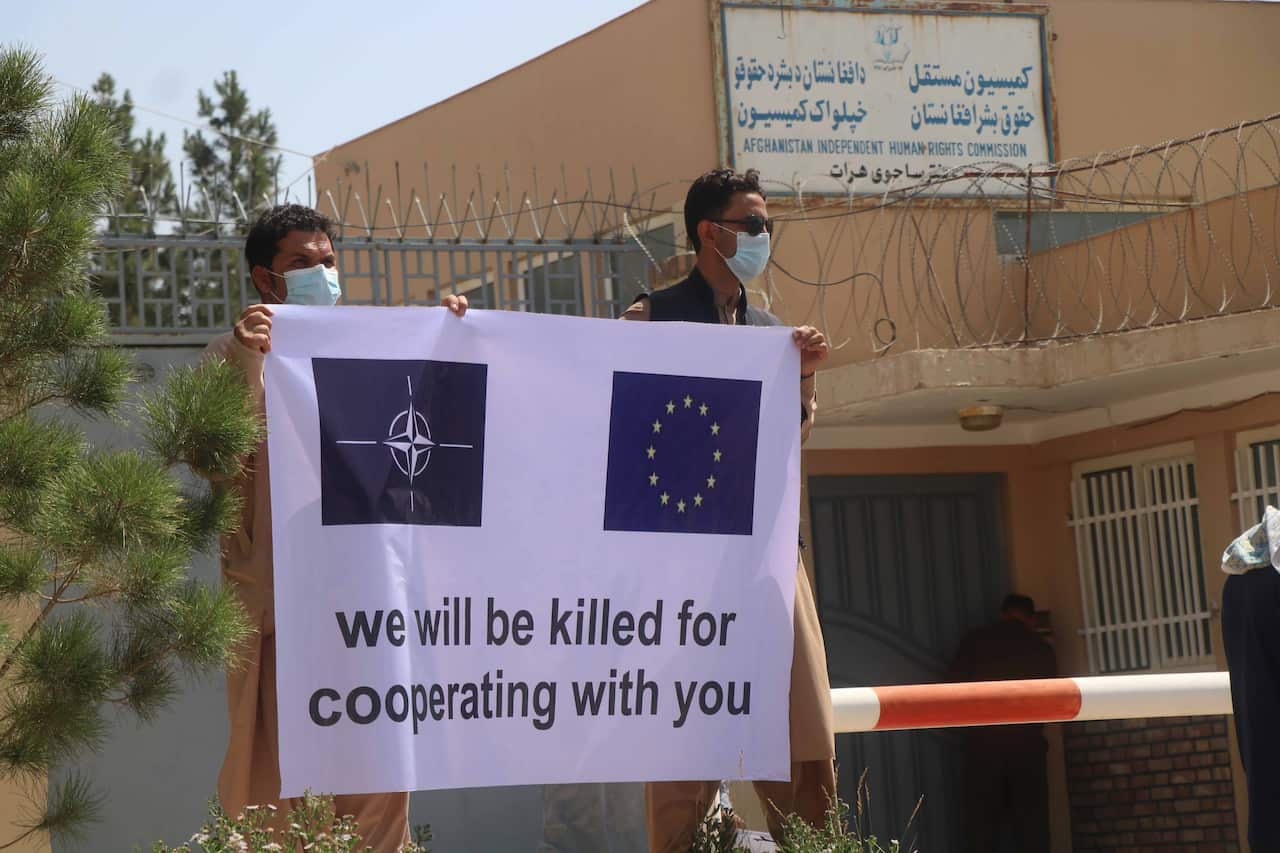 Afghan contractors, working for Italian soldiers of NATO's Resolute Support Mission hold placards during a protest in Herat, Afghanistan, 09 June 2021.
