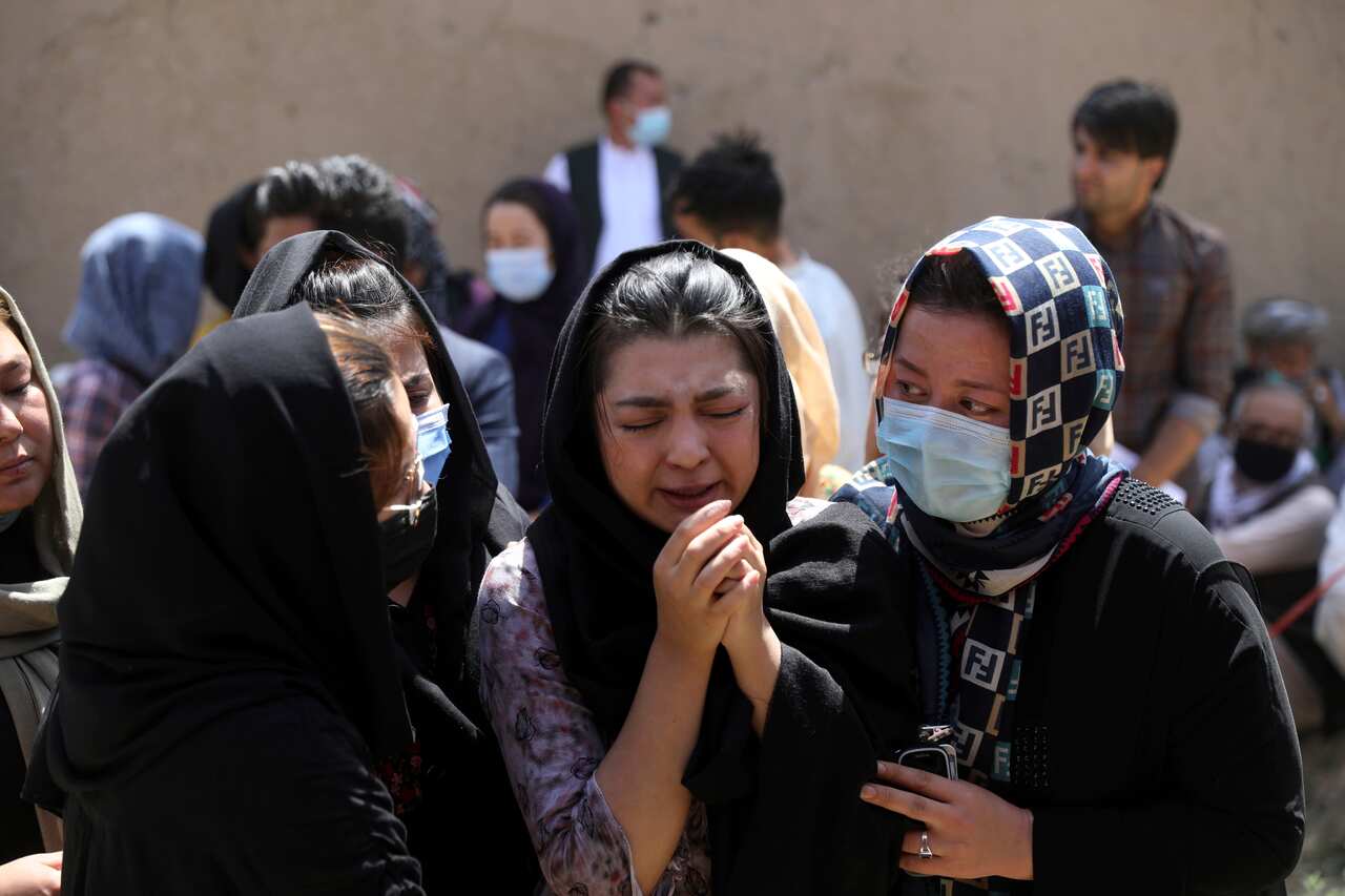Afghan Hazaras mourning after a string of minivan bombings in their Kabul neighbourhoods last month.