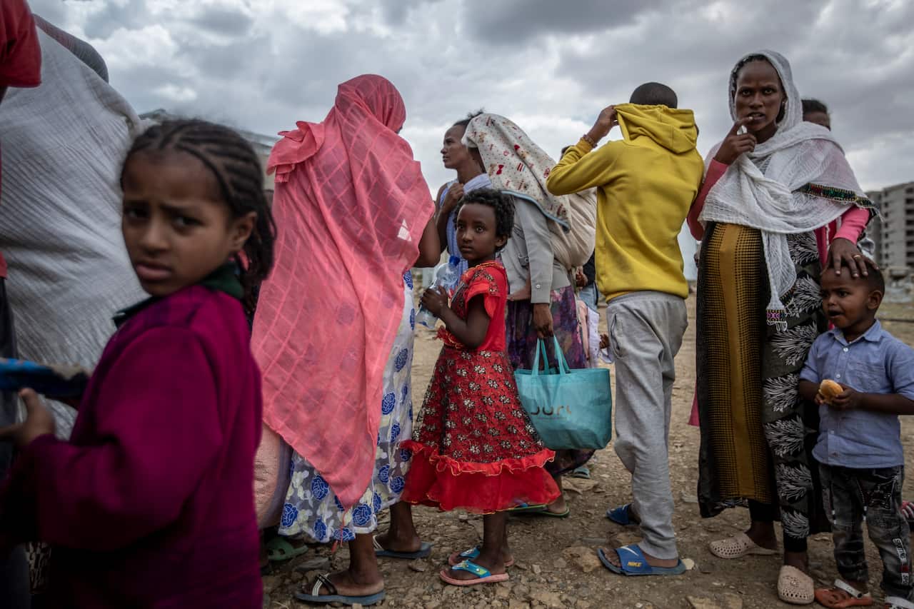 Displaced Tigrayans wait to receive food donated by local residents at a reception centre for the internally displaced in Mekeleon, Ethiopia, on 9 May, 2021.