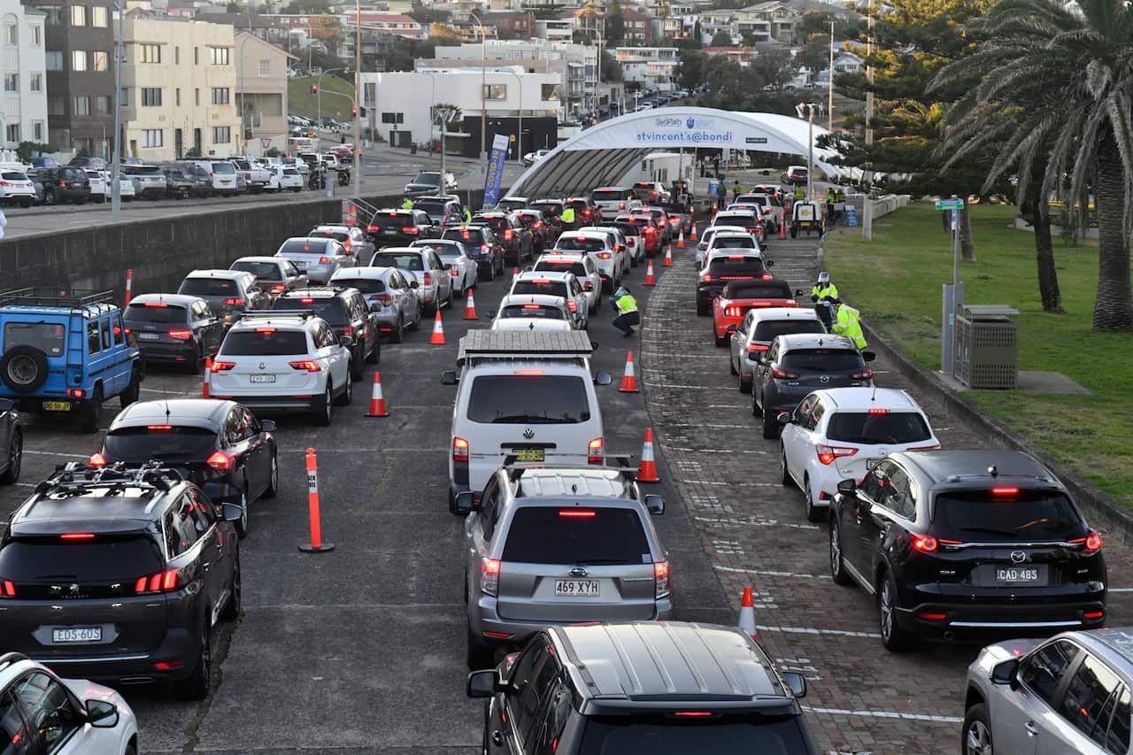 Members of the public wait to be tested for COVID-19 at a pop up clinic at Bondi Beach in Sydney, Saturday, 26 June, 2021. 