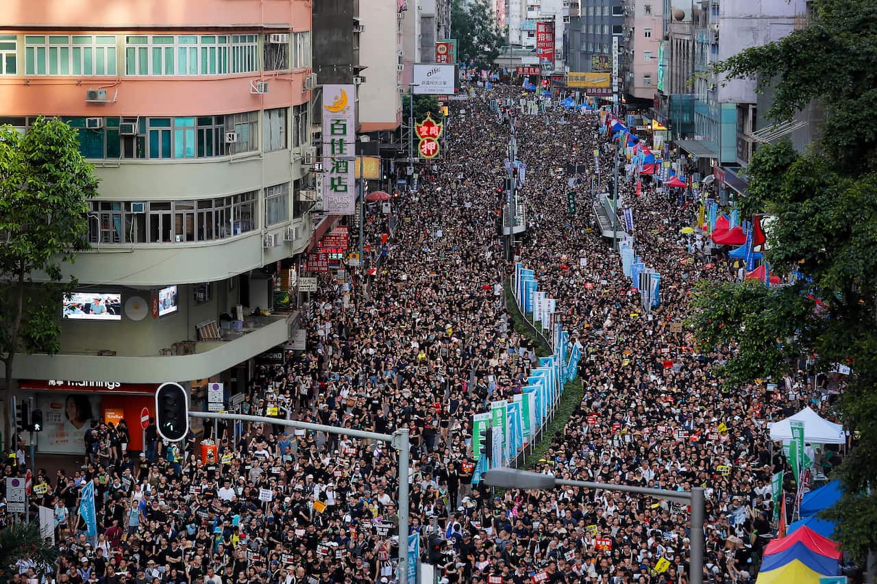 In this 1 July, 2019 file photo, protesters flood the streets as they take part in an annual rally in Hong Kong.