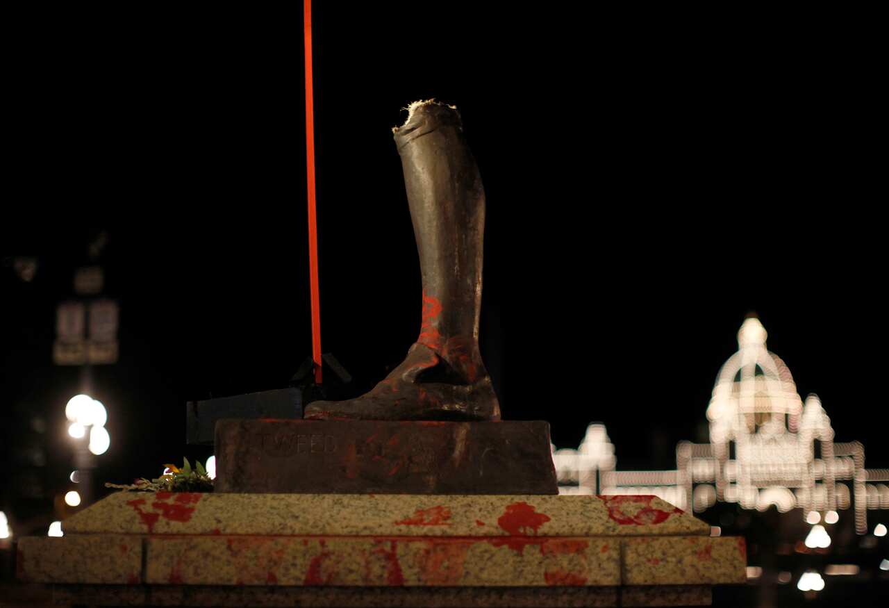 The statue of English explorer James Cook was removed from its base and tossed into the harbour
