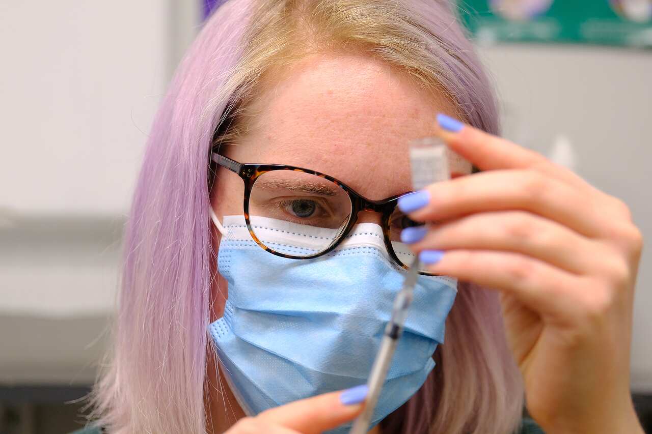 A medical staffer at Midtown Medical Clinic prepares a dose of the Pfizer vaccine on Monday, 5 July, 2021. 