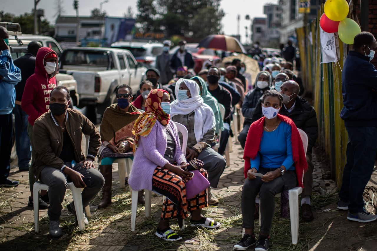 Ethiopians wait to cast their votes in the general election at a polling centre in the capital Addis Ababa, Ethiopia, Monday, June 21, 2021.