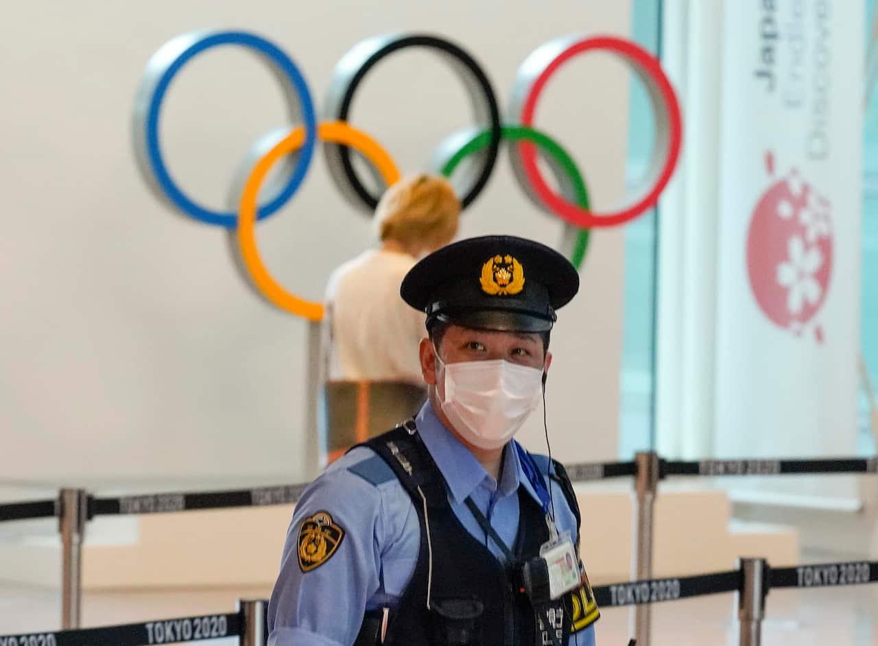 A Japanese policeman stands on guard at an arrival exit of Tokyo International Airport at Haneda, Japan.