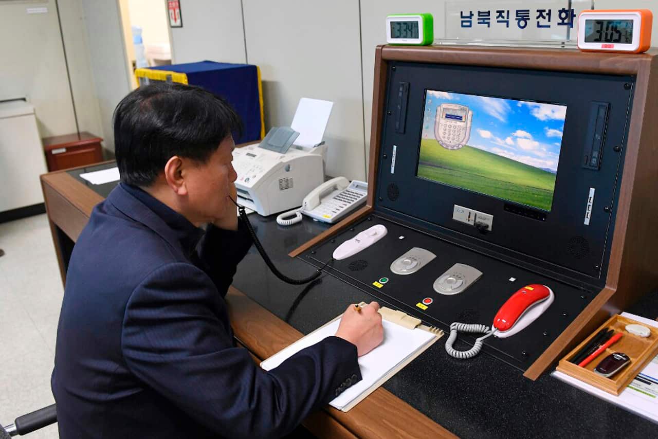 A South Korean government official communicates with a North Korean officer on the dedicated communications hotline at the border village of Panmunjom.