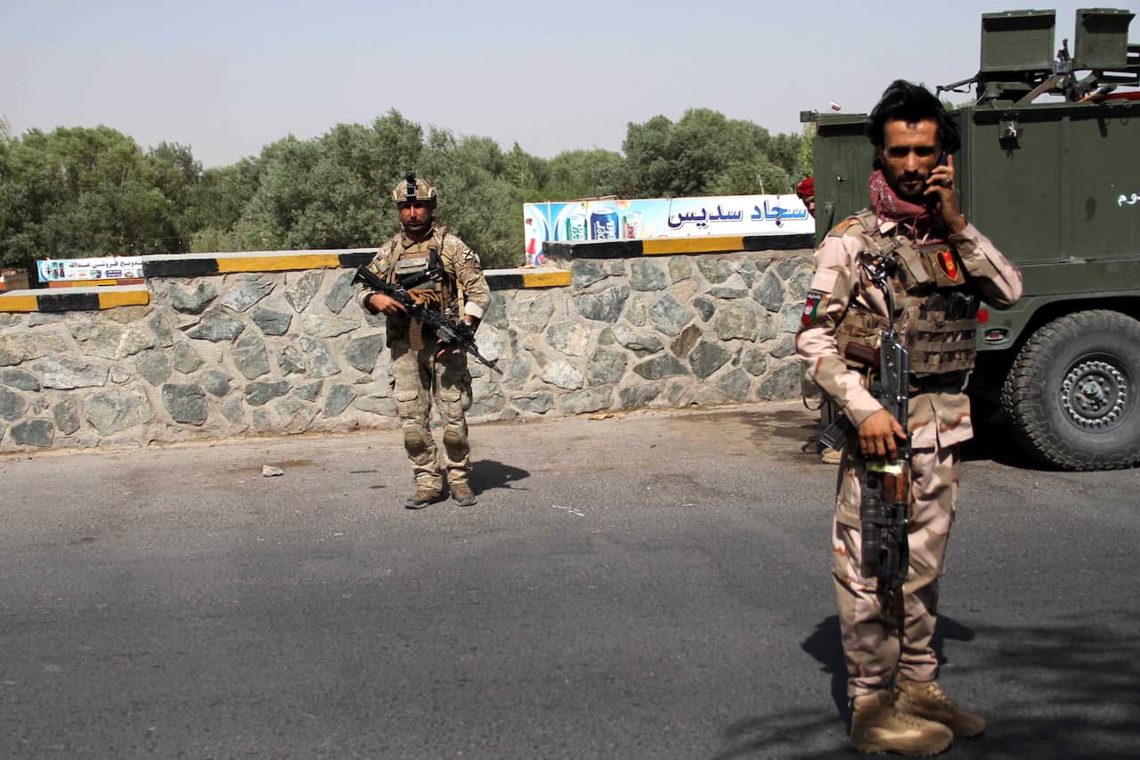 Afghan security officials stand guard at a roadside check point in Herat, Afghanistan, 31 July 2021.
