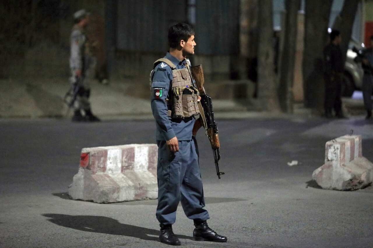 Afghan security personnel stand guard at the site of a powerful explosion in Kabul, Afghanistan, Tuesday, 3 August, 2021.
