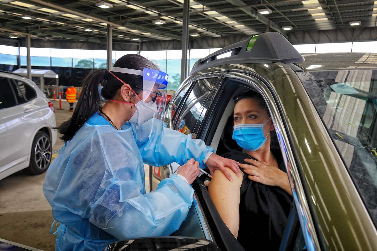 A drive through patient gets vaccinated at the new western health drive through COVID-19 vaccination centre in Melton, Sunday, August 8, 2021. 