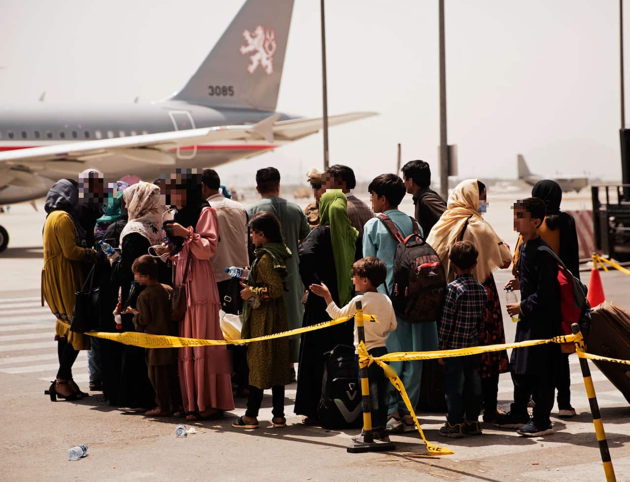 Afghans prepare to board a US plane during an evacuation at Hamid Karzai International Airport, Kabul. 