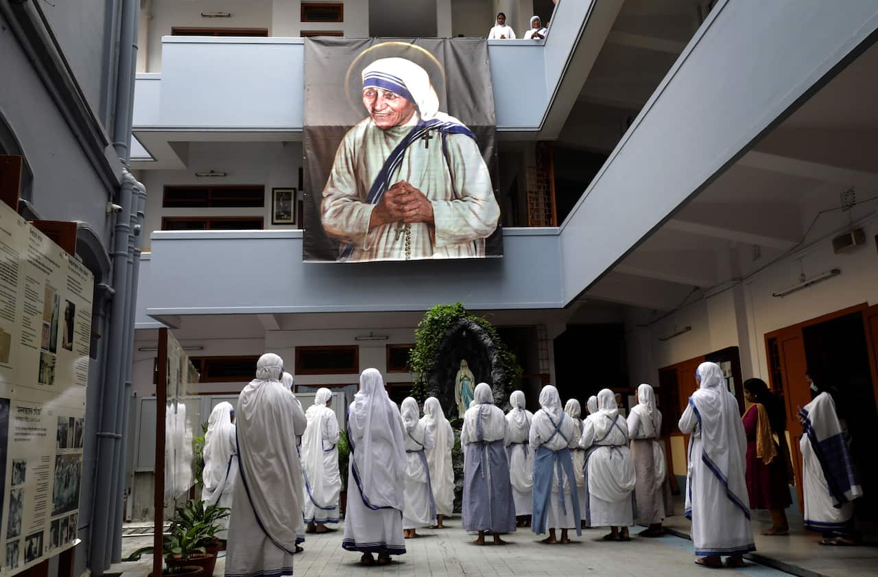 Nuns take part in a mass prayer at Mother House on Mother Teresa's 111th birth anniversary in Kolkata