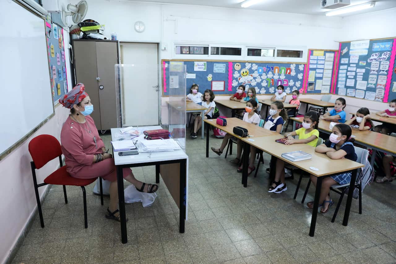 Teacher and children in class at an elementary school on the first day of school in Jerusalem.