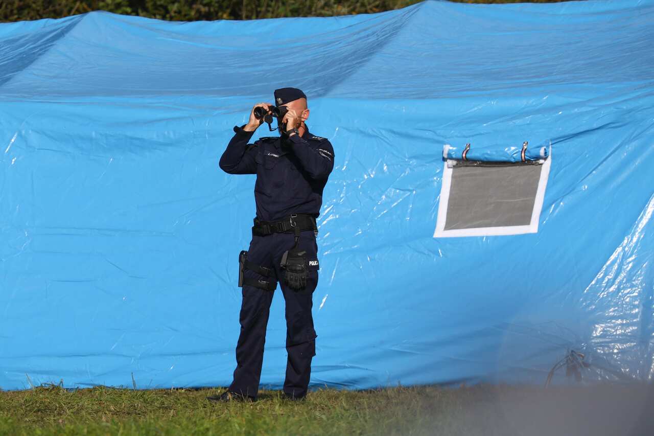 Police are seen cordoning off an area along the border in Usnarz Gorny, Poland.