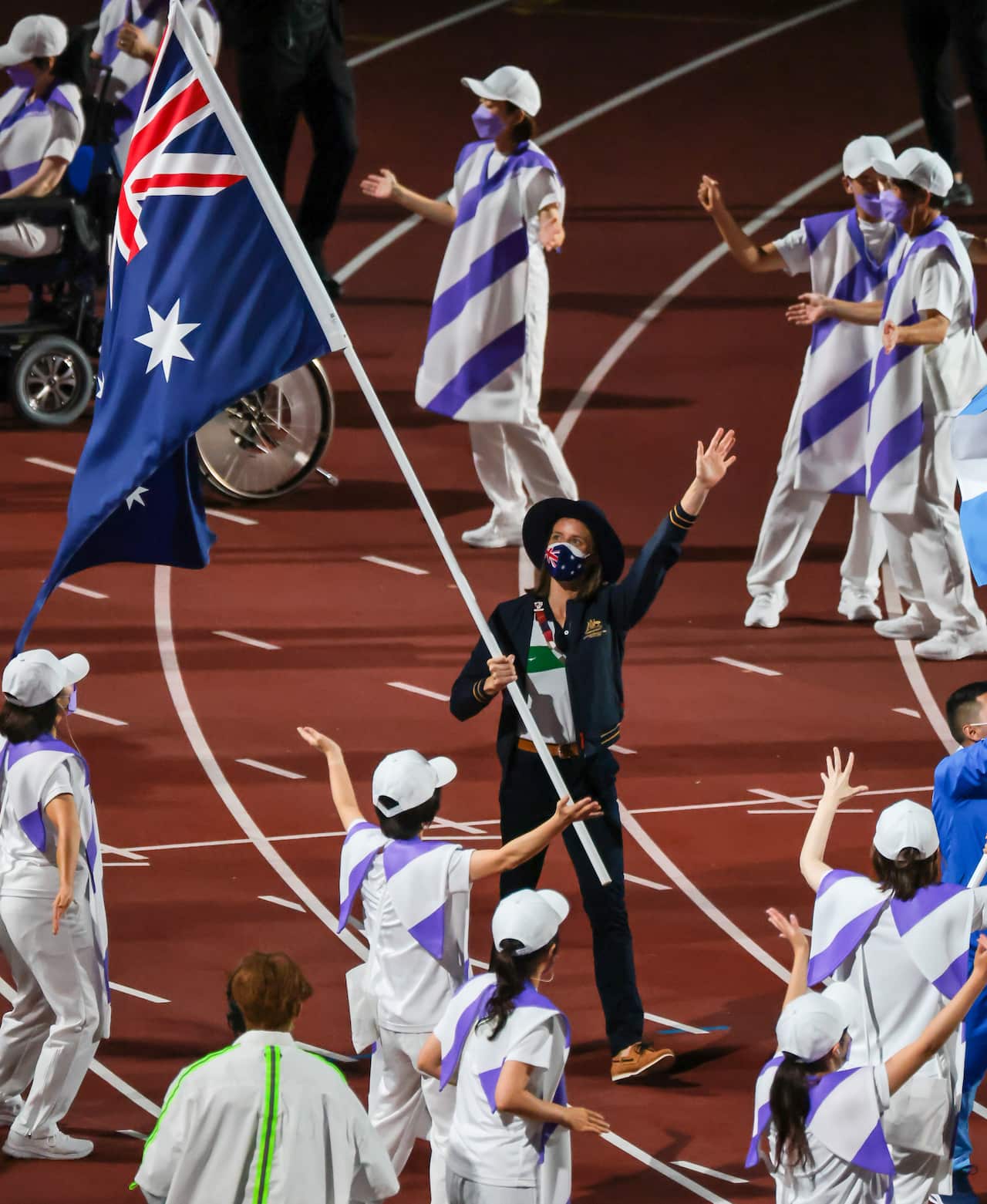 Australia’s Ellie Cole carries the Australian Flag during the closing ceremony of the Tokyo Paralympic Games in Tokyo, Sunday, September 5, 2021, (AAP Image/Paralympics Australia/Sport the Library/Greg Smith) NO ARCHIVING, EDITORIAL USE ONLY