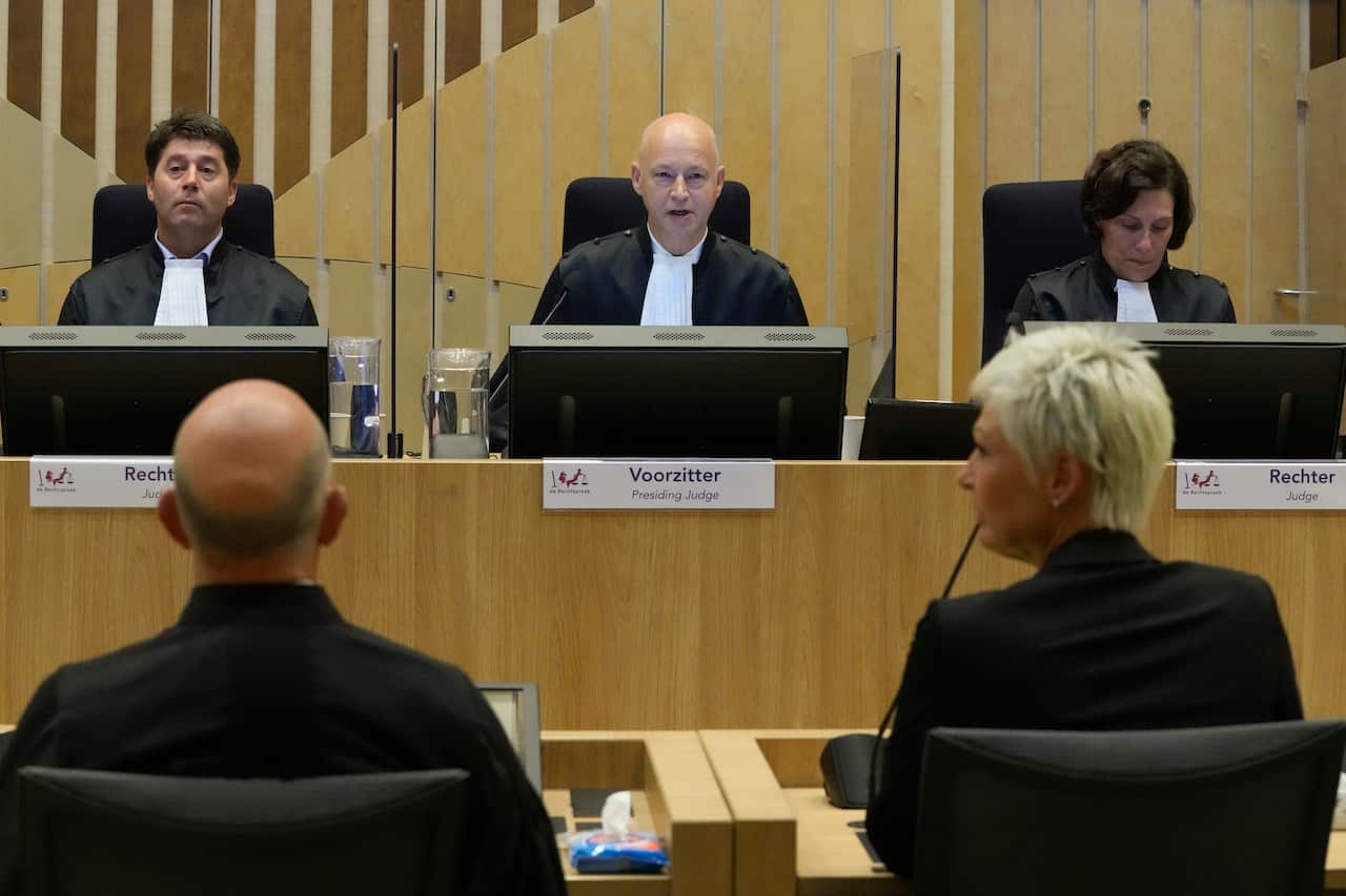 Presiding judge Hendrik Steenhuis waits for Ria van der Steen, who lost her father and stepmother in the MH17 crash.