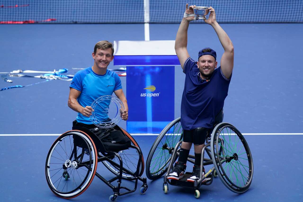 Dylan Alcott, of Australia, right, and Niels Vink, of the Netherlands, pose for a picture after Alcott defeated Vink in the men's wheelchair quad singles final.
