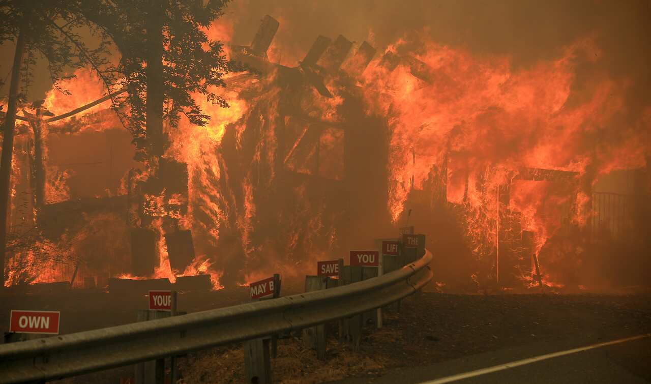 A home burns along Marina Drive above Lake Mendocino during the Hopkins fire, Sunday, Sept. 12, 2021 in Calpella, Calif. in Mendocino County. (Kent Porter/Santa Rosa Press Democrat via AP)