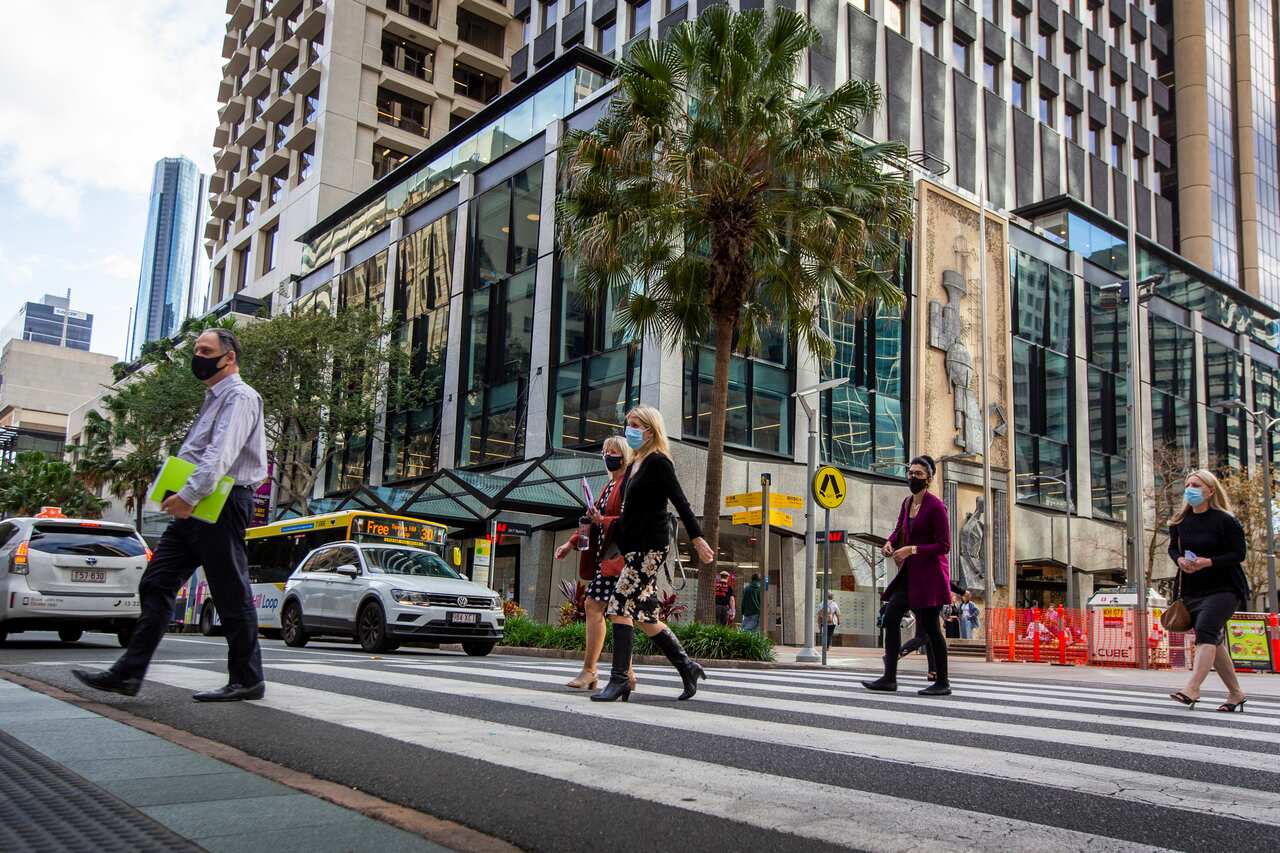 Pedestrians are seen wearing masks in the Brisbane CBD