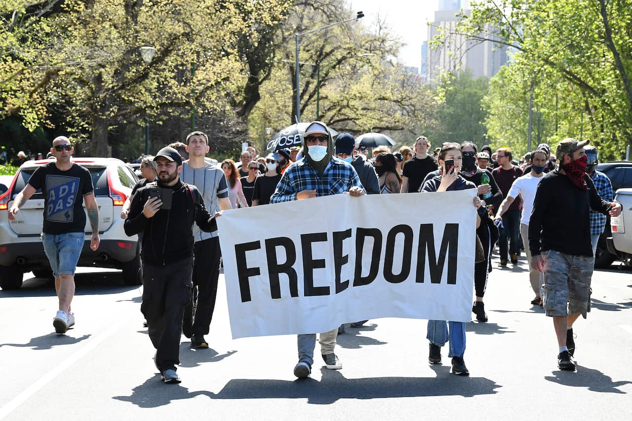 Protesters are seen during a protest in Melbourne, Saturday, October 2, 2021. (AAP Image/James Ross) NO ARCHIVING