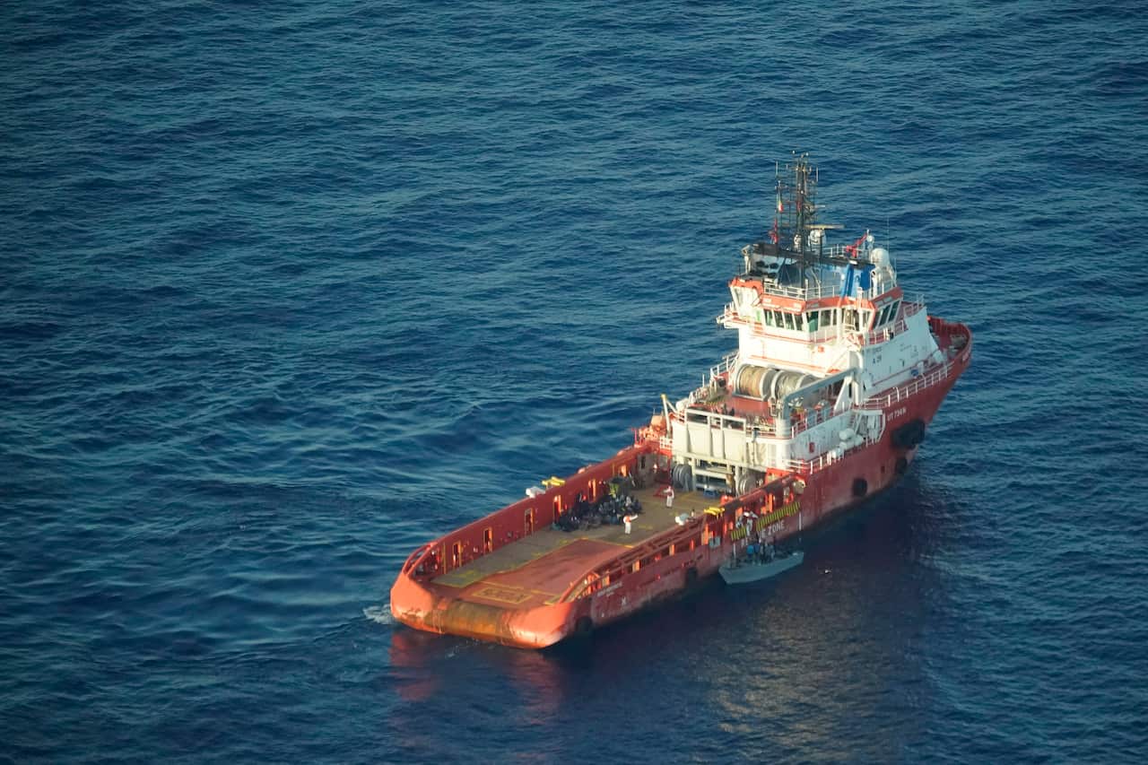 Rescued migrants sit on the deck of the Italian supply vessel Asso Ventinove after being rescued from an overcrowded wooden boat drifting north of Libya
