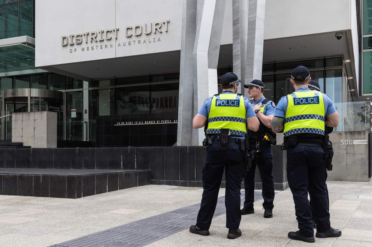 Police are seen outside the District Court of West Australia, in Perth.
