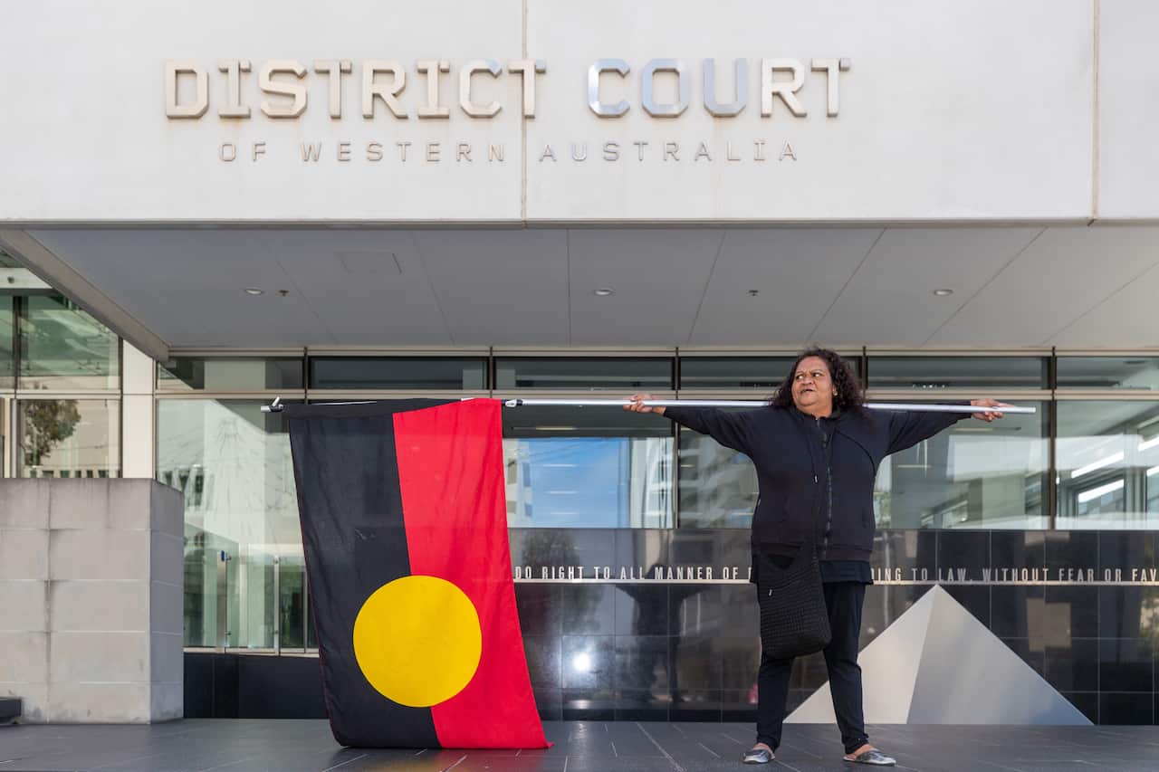 A supporter of a woman referred to as JC at family's request outside the District Court of Western Australia in Perth.