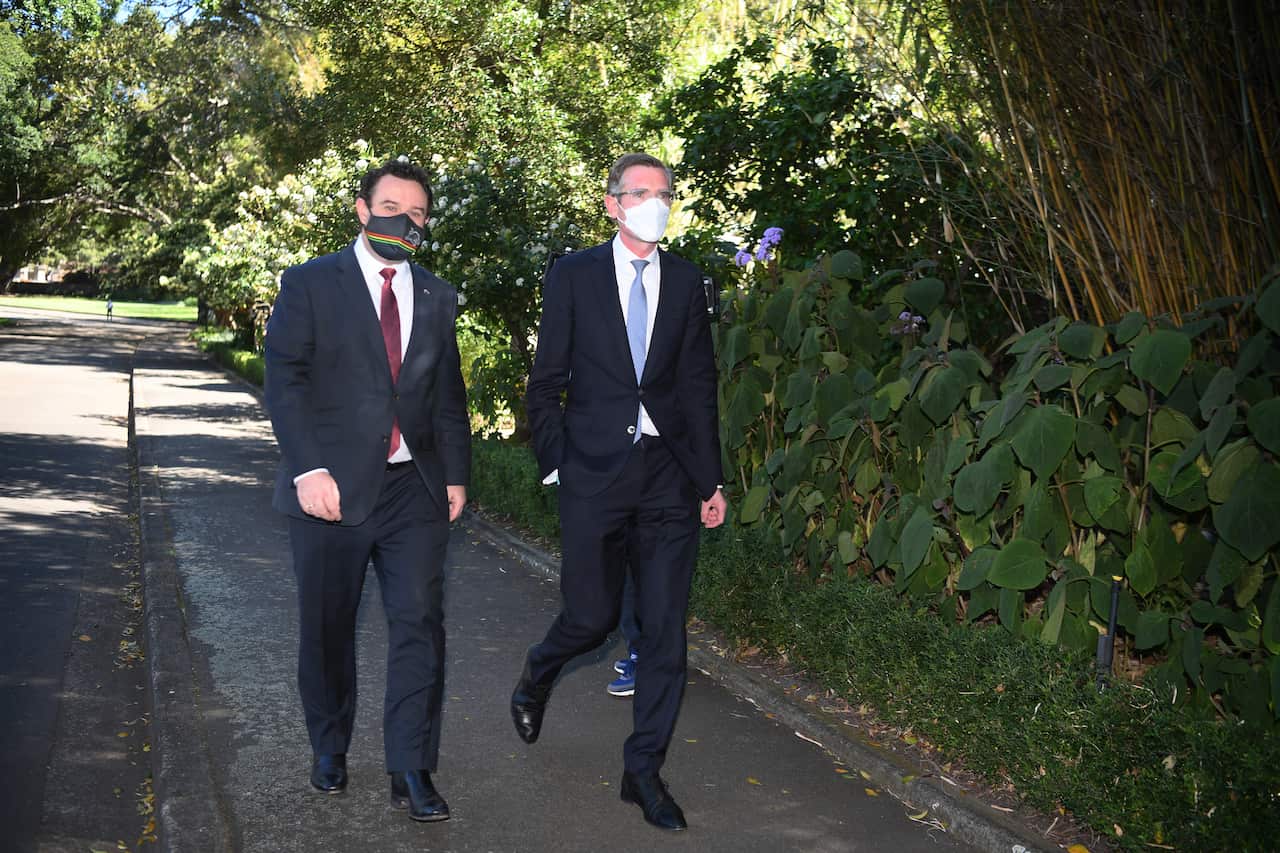 Newly elected Premier Dominic Perrottet (right) arrives with Deputy Leader Stuart Ayres (left) for a swearing in ceremony at NSW Government 