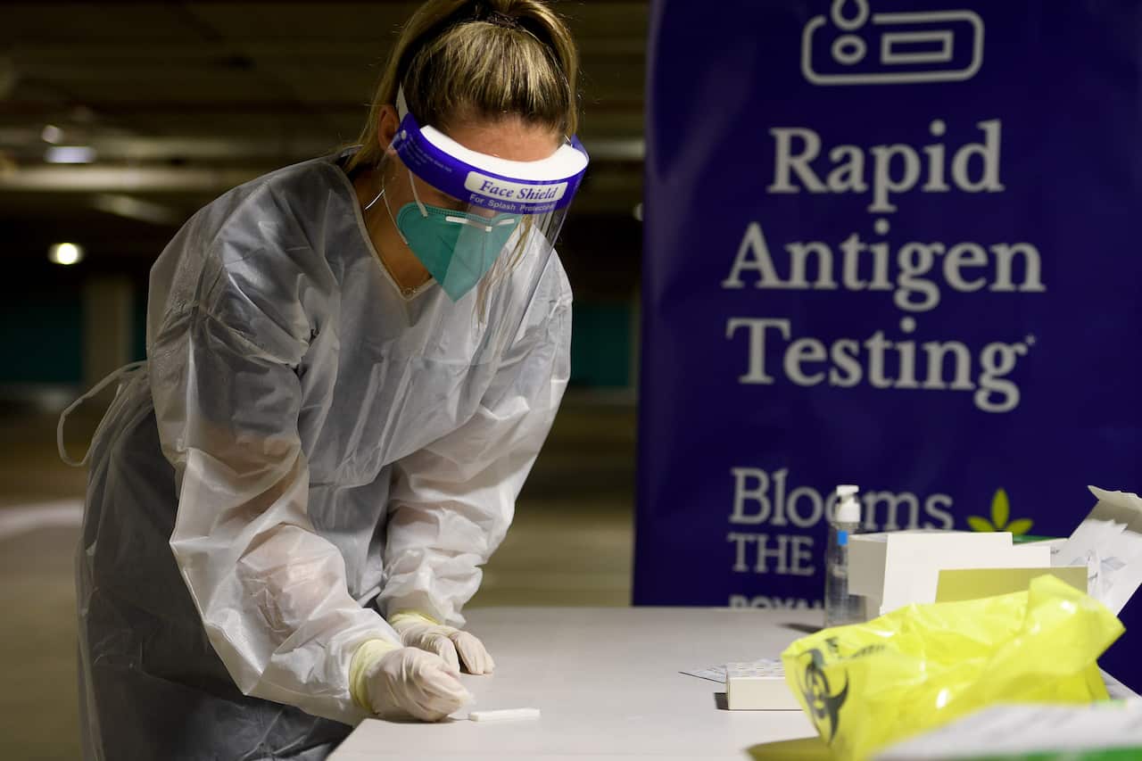 Nurse Niamh Costello demonstrates a Covid-19 rapid antigen test at a drive-through testing facility in Sydney.