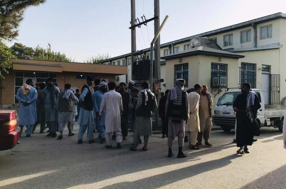 People gather near the scene of a bomb blast that targeted a Shiite Muslims mosque in Kunduz, Afghanistan, 08 October 2021. 