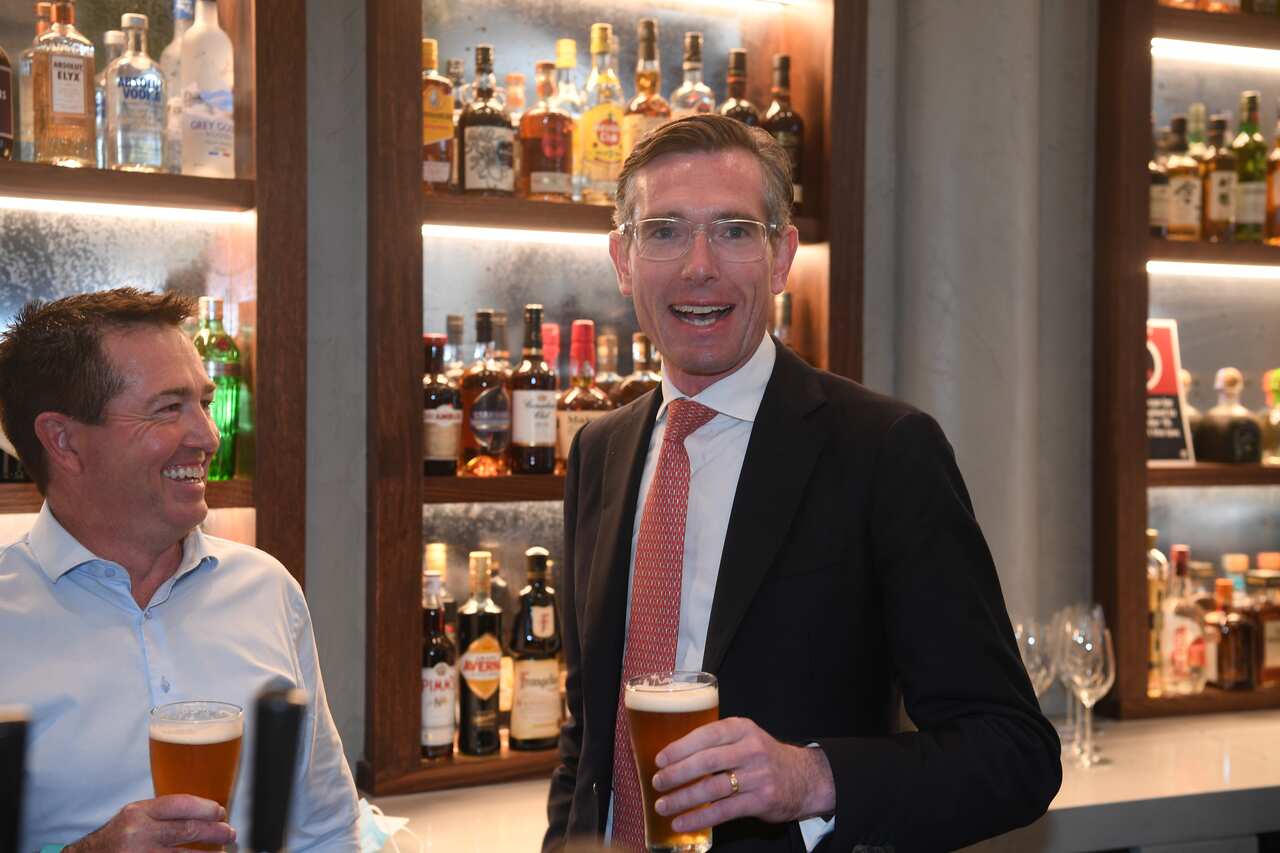 NSW Premier Dominic Perrottet and NSW Deputy Premier Paul Toole enjoy a beer at Watson’s Pub in Sydney, Monday, October 11, 2021. (AAP Image/Dean Lewins) NO ARCHIVING
