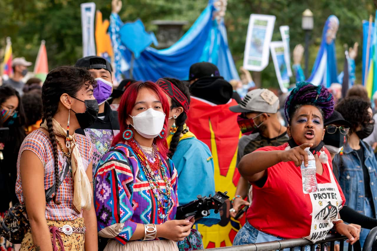Indigenous and environmental activists protest in front of the White House in Washington DC.