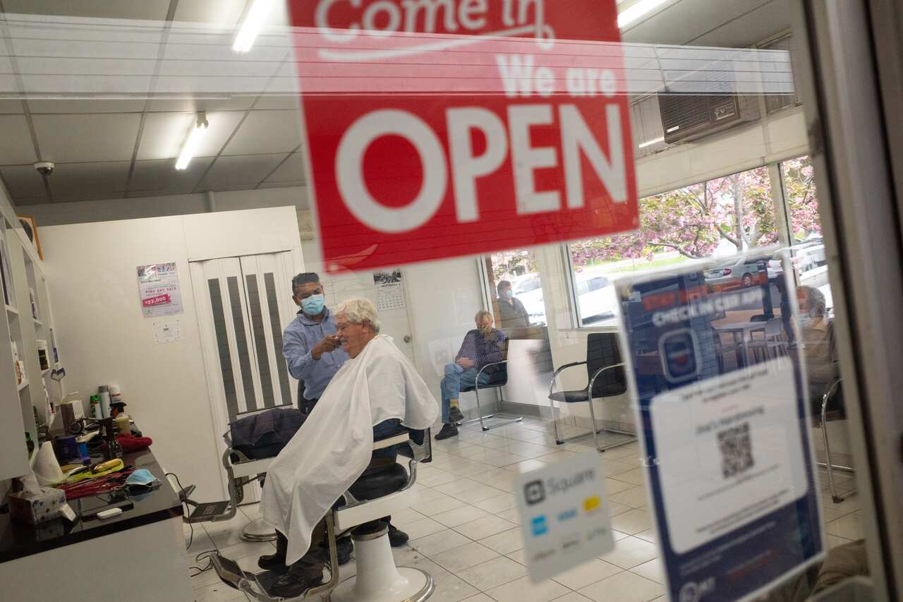 A customer receives a hair cut at Jinas Hairdressing in Canberra, Friday, October 15, 2021. 