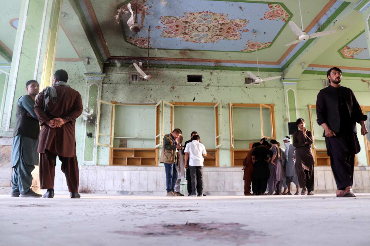 People inspect the scene of the bomb blasts 