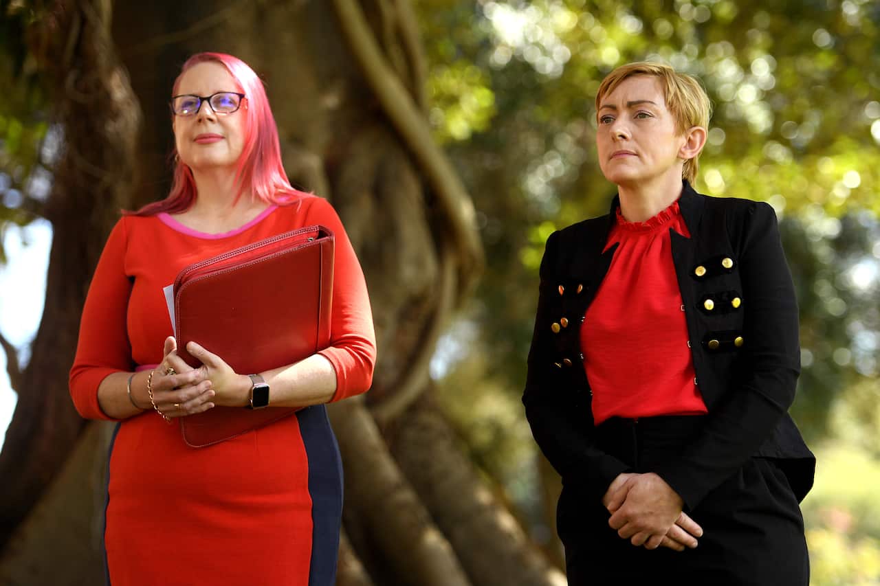 Chair of Domestic Violence NSW Annabelle Daniel and victim-survivor Wendy Boyd watch on during a press conference in Sydney, Tuesday, 19 October, 2021.