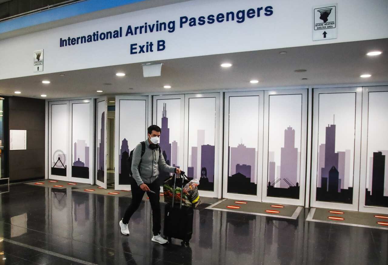 A passenger from a United Airlines flight from Frankfurt, Germany arrives at O'Hare International Airport in Chicago, USA on 8 November 2021. 